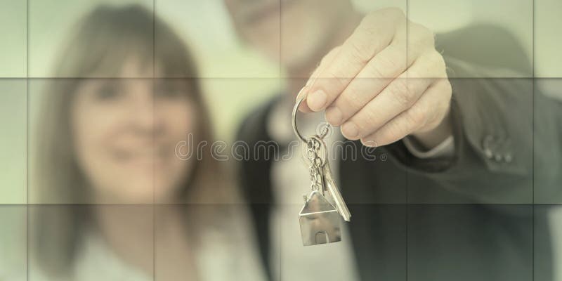 Senior couple showing house keys light effect geometric pattern happy immagine stock