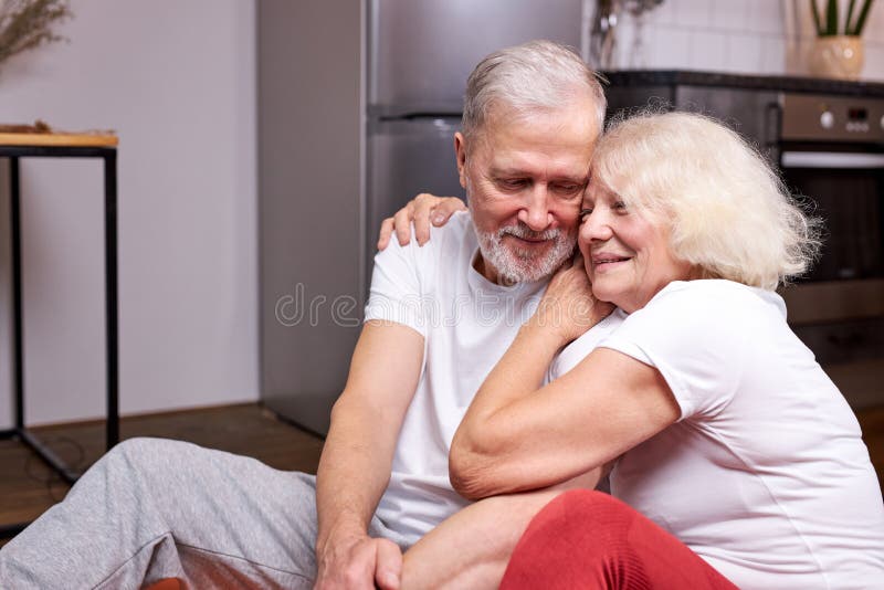 beautiful senior couple sit having rest on the floor royalty free stock photos