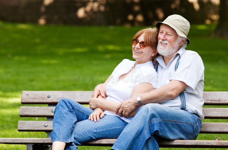 Senior couple sitting on a park bench royalty free stock photography Senior couple sitting on a park bench royalty free stock photography