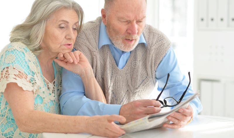 Senior couple reading newspaper