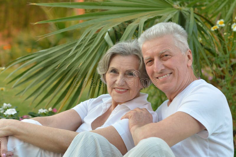 Senior Couple Sitting At Garden