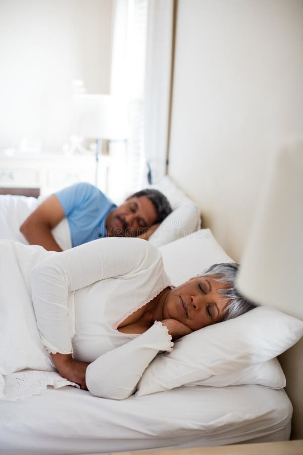 Senior Couple Sleeping Together on Bed in Bedroom Stock Image Image