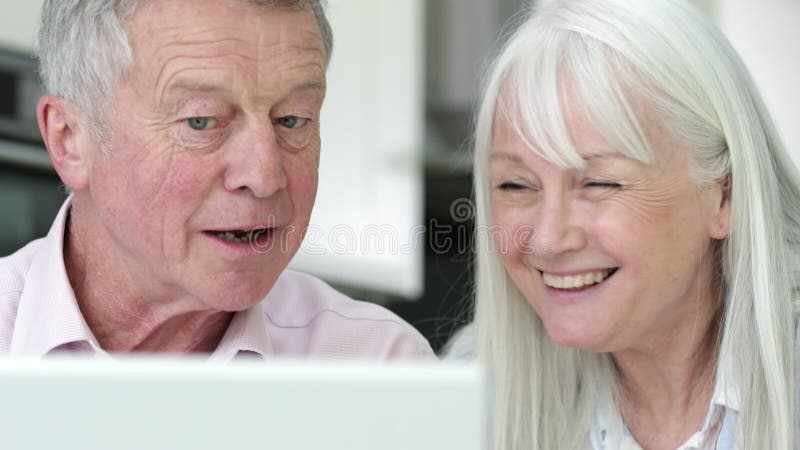 Senior Couple Using Laptop To Connect With Family