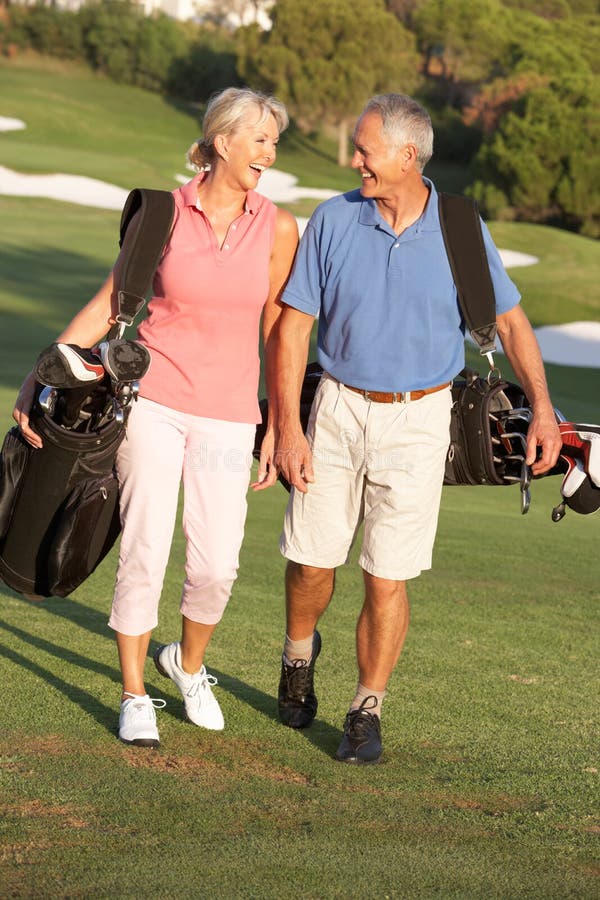 Senior Couple Walking Along Golf Course Stock Image Image of club