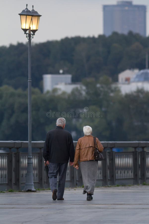 Senior couple walking in park at evening royalty free stock photo Senior couple walking in park at evening royalty free stock photo