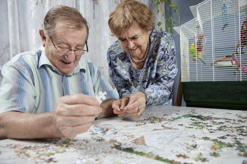 Senior couple working on a puzzle. At home royalty free stock photos