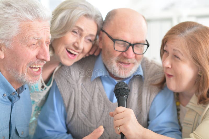 Senior couples reading newspaper stock photography Senior couples reading newspaper stock photography
