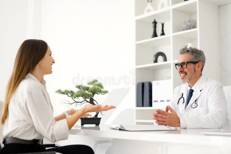 A conversation between a healthcare professional and a patient during appointment stock photography