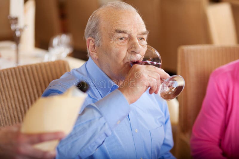 Senior Drinking a Glass of Red Wine in Restaurant Stock Image Image