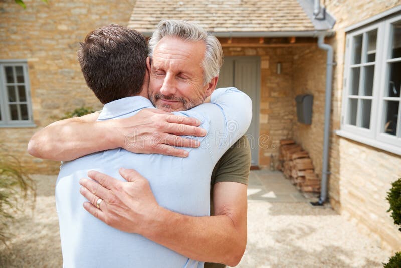 Senior Father Greets and Hugs Adult Son Outside Front Door of House As he  Visits Stock Image - Image of greeting, love: 163727053