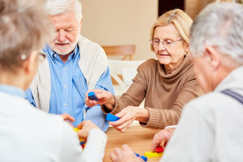 Senior group plays with colorful building blocks royalty free stock photo Senior group plays with colorful building blocks royalty free stock photo