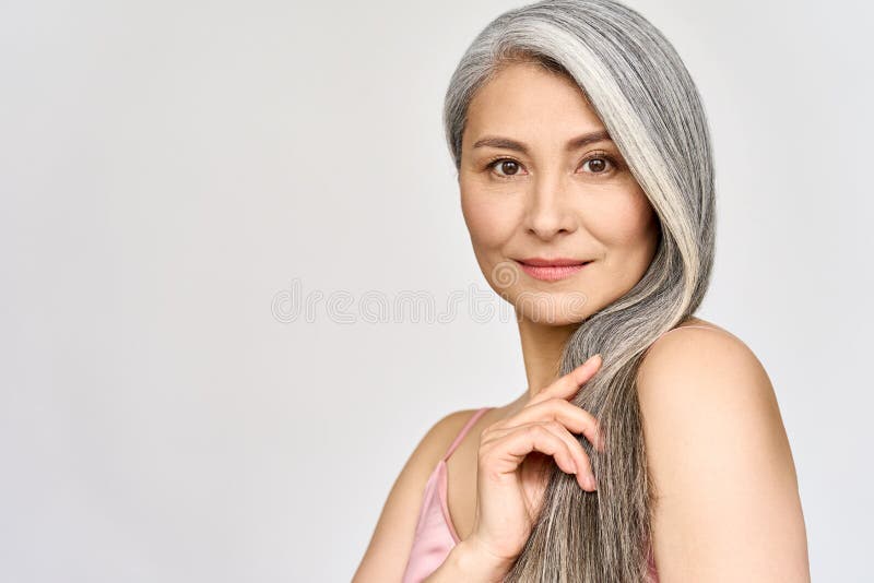 Senior happy middle aged mature asian woman headshot portrait. Hair care advertising.