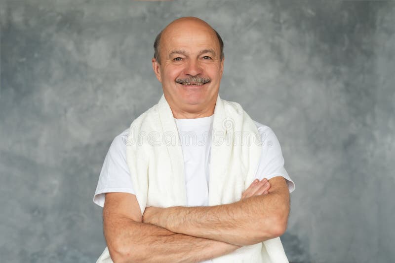 Senior hisanic man after shaving standing with white towel and smiling. royalty free stock photography Senior hisanic man after shaving standing with white towel and smiling. royalty free stock photography