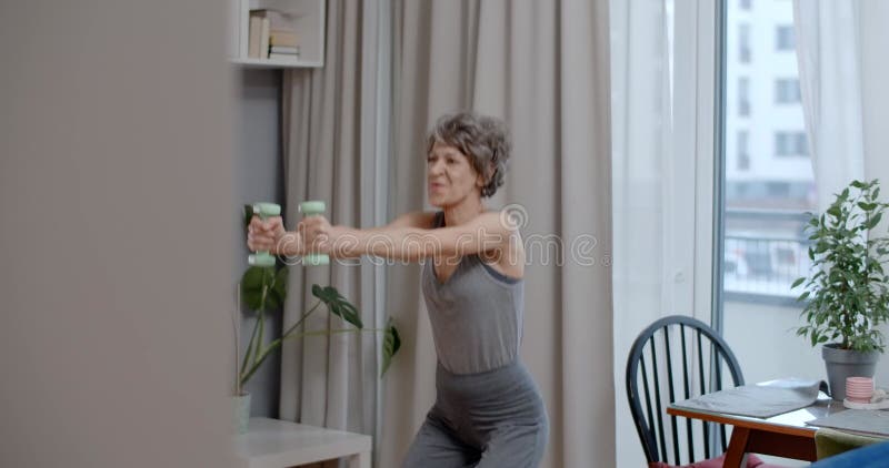 Elderly Lady is Doing Energizing Dumbbell Exercises at Home, Fitness ...