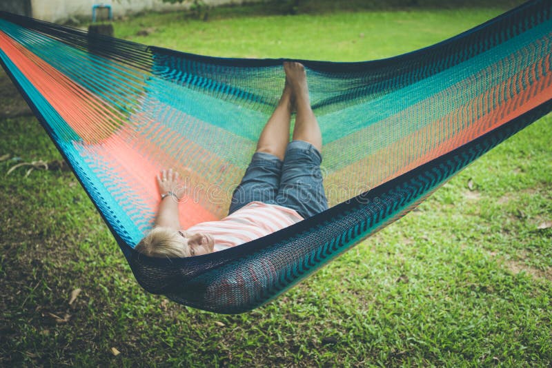 Senior lady relaxing in a hammock royalty free stock photography Senior lady relaxing in a hammock royalty free stock photography