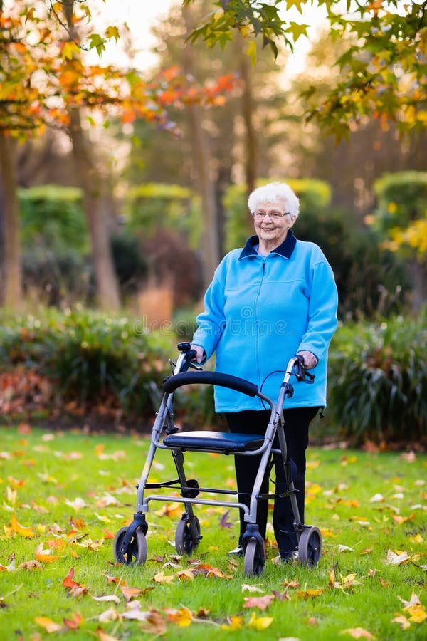 Senior Lady with a Walker in Autumn Park Stock Photo - Image of ...