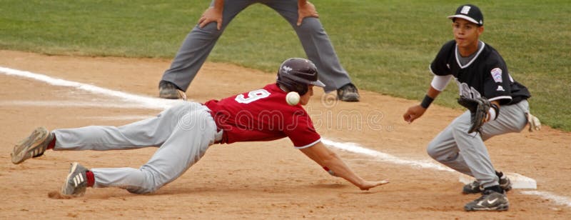 BANGOR, MAINE - AUGUST 18: Wyatt Frost of Maine District 3 (Bangor East/West L.L.) slides safely back to first base as the pickoff attempt is about to be caught by Andrew Biggs of U.S. East (South Vineland L.L., New Jersey) at the 2010 Senior League Baseball World Series on August 18, 2010 in Bangor, Maine. BANGOR, MAINE - AUGUST 18: Wyatt Frost of Maine District 3 (Bangor East/West L.L.) slides safely back to first base as the pickoff attempt is about to be caught by Andrew Biggs of U.S. East (South Vineland L.L., New Jersey) at the 2010 Senior League Baseball World Series on August 18, 2010 in Bangor, Maine.