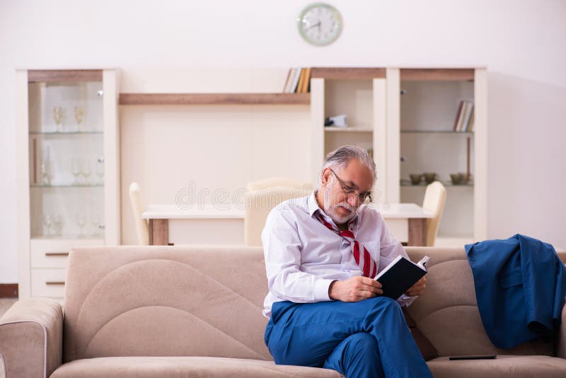 Old male boss employee coming home from work stock photo