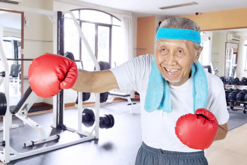 Senior male boxer exercising in the gym center
