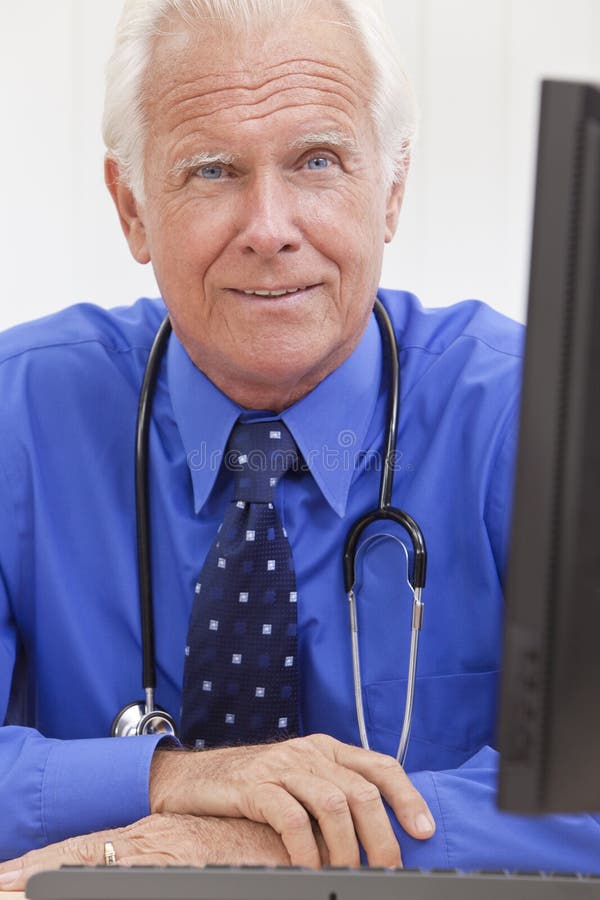 Senior Male Doctor with Stethoscope at Desk Stock Image - Image of ...