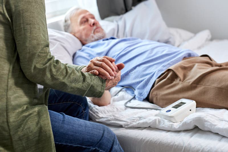 senior male patient at hospital with worried wife sitting with him royalty free stock photos