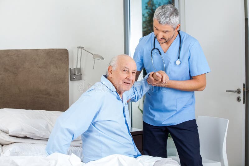Senior Man Being Assisted By Male Caretaker In royalty free stock images Senior Man Being Assisted By Male Caretaker In royalty free stock images