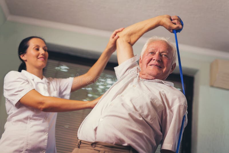Senior man doing exercises using a strap stock image Senior man doing exercises using a strap stock image