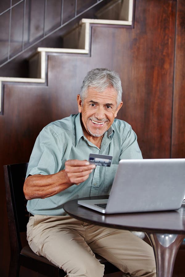 Senior man doing online shopping with credit card stock images Senior man doing online shopping with credit card stock images