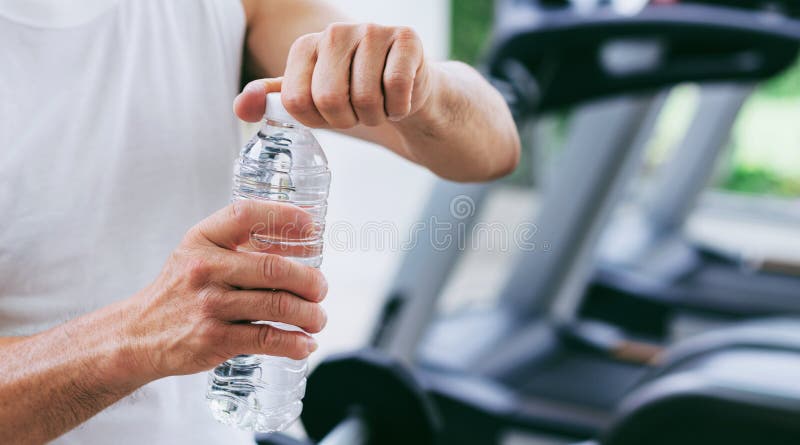 Senior man drink mineral water in fitness center royalty free stock photos Senior man drink mineral water in fitness center royalty free stock photos