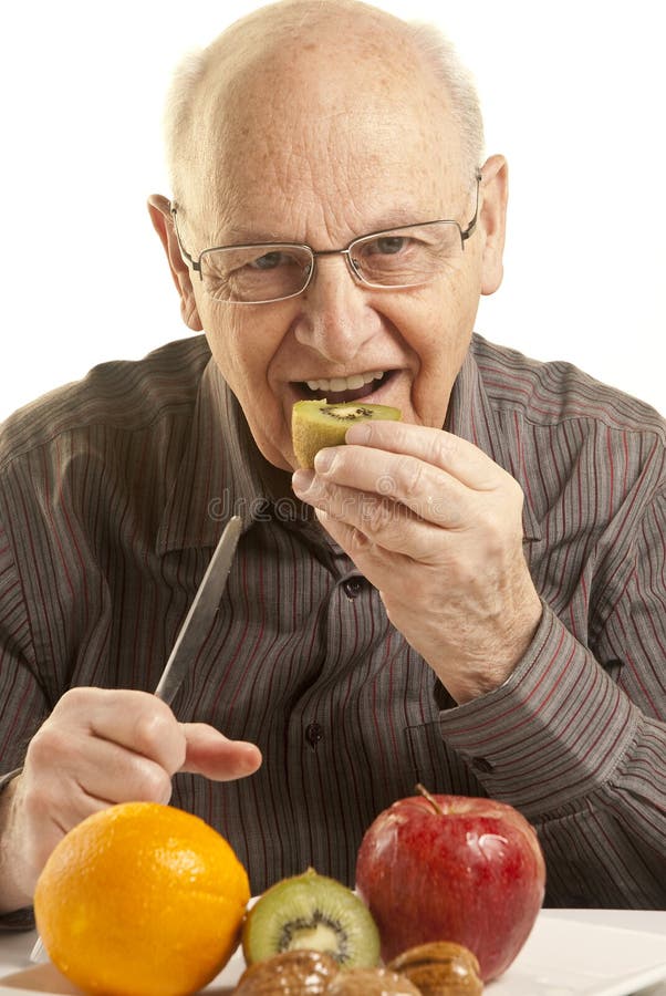 Senior man eating fresh fruit royalty free stock photo Senior man eating fresh fruit royalty free stock photo