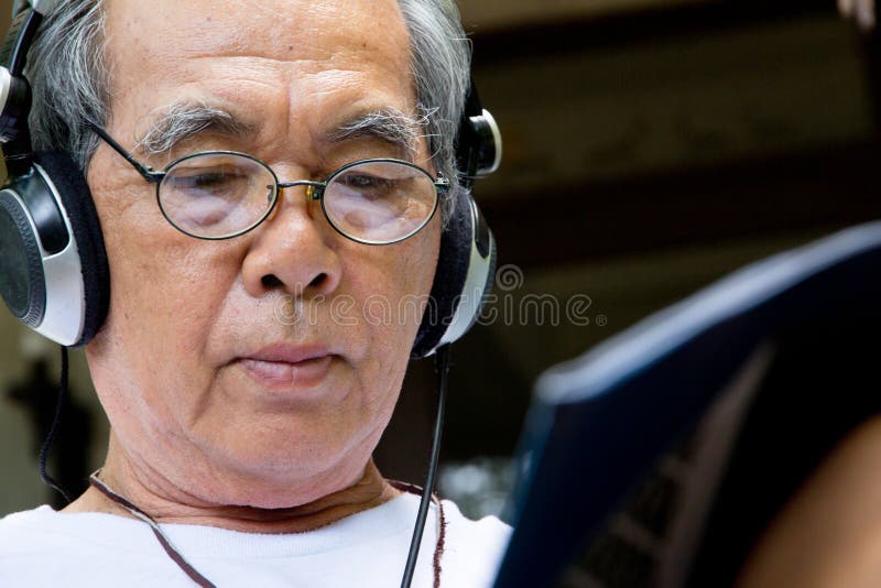 Senior man enjoying music