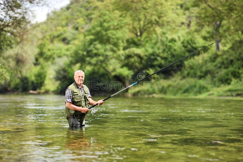 Senior man fishing in a river on a sunny day