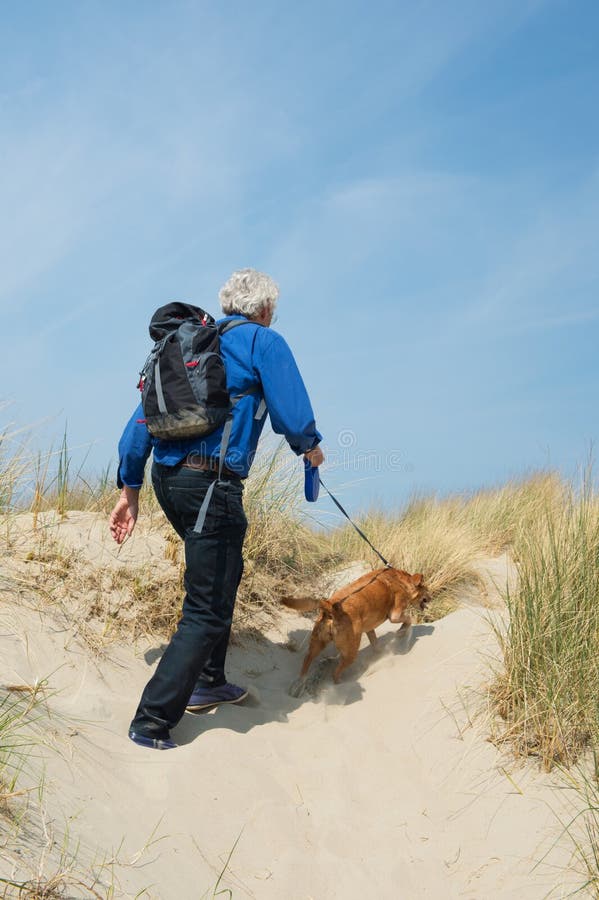 Senior man hiking with dog