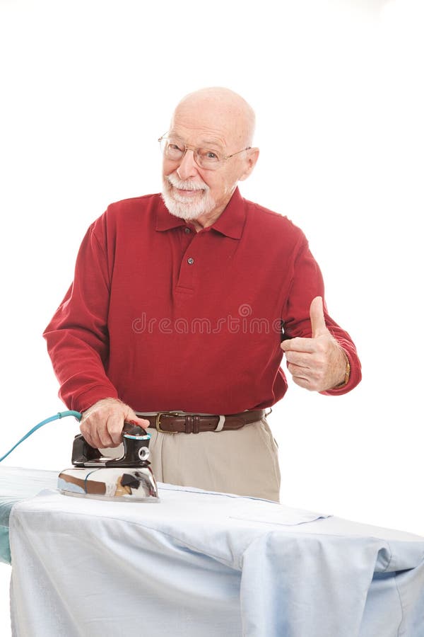 Senior Man Irons His Shirt stock image Senior Man Irons His Shirt stock image