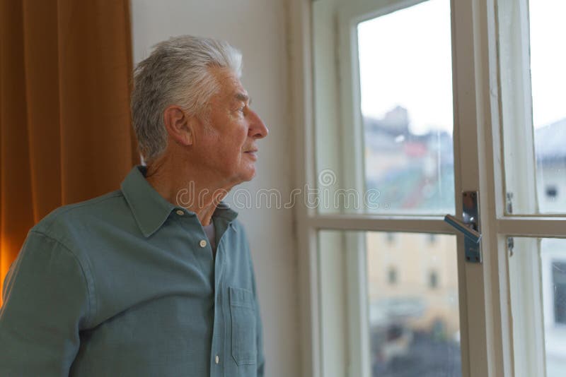 Photo of a Man Looking Outside of His Window · Free Stock Photo