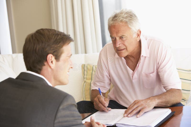 Senior Man Meeting With Financial Advisor At Home royalty free stock image