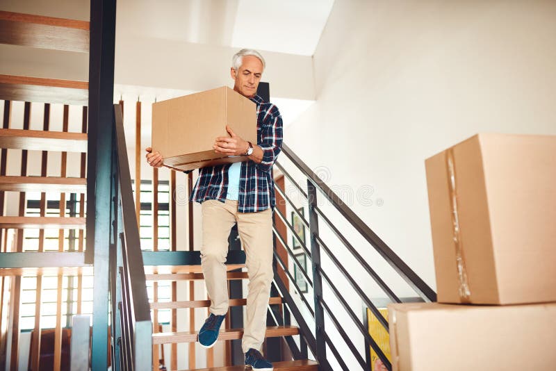 Senior man, moving and box in home by stairs for real estate, property ownership and relocation. House, steps and royalty free stock photos