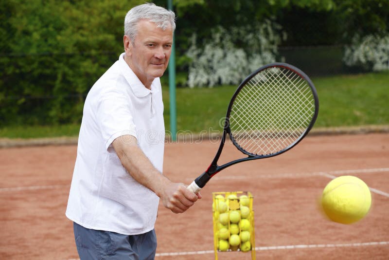 Senior man playing tennis stock photo. Image of retirement 72836050