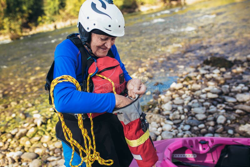 Senior Man Preparing for Kayak Tour on a Mountain River Stock Photo