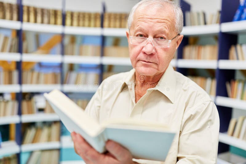 Senior man reads in a book stock image Senior man reads in a book stock image