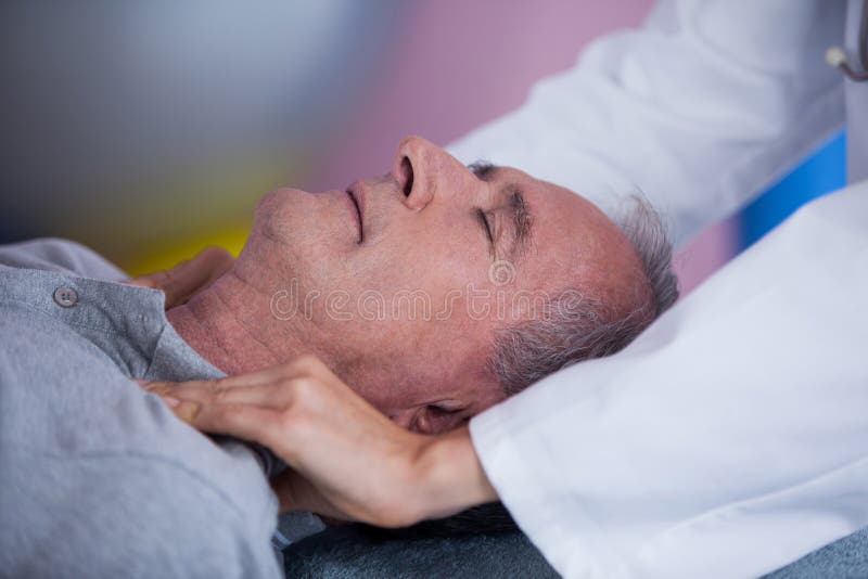 Senior man receiving shoulder massage from physiotherapist stock image Senior man receiving shoulder massage from physiotherapist stock image