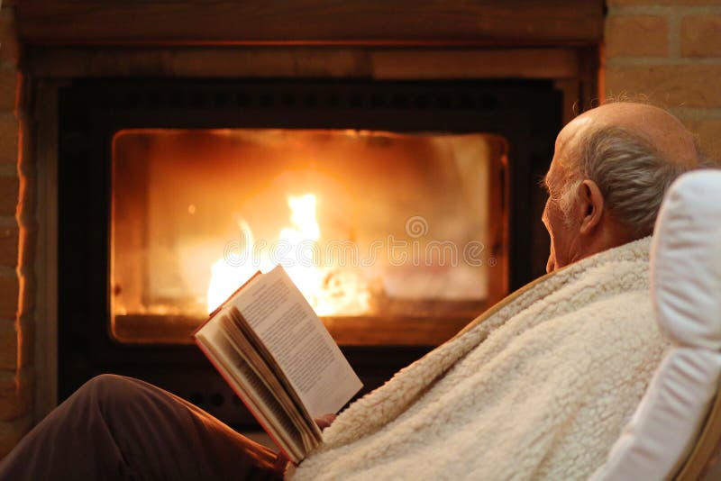 Senior Man Relaxing By Fireplace Stock Photo - Image of 