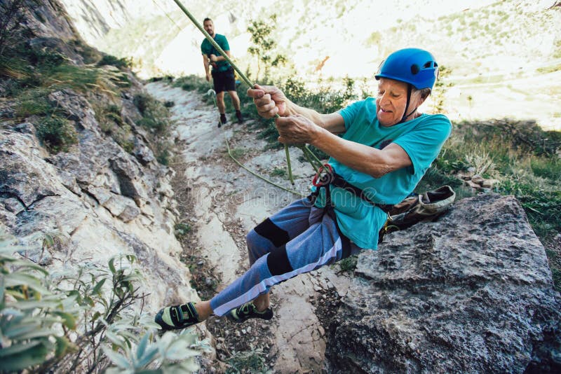 Senior Man with a Rope Climbing on the Rock Stock Photo Image of