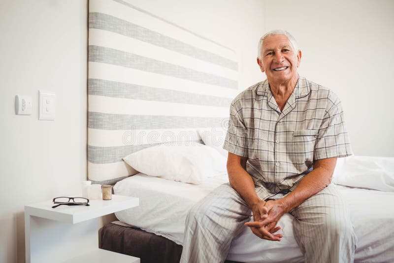 Senior man sitting on bed royalty free stock images Senior man sitting on bed royalty free stock images