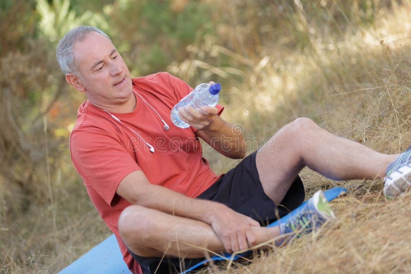 Senior Man Sitting In Park And Holding Bottle Water Stock Image Image Of Senior Pond 103625339