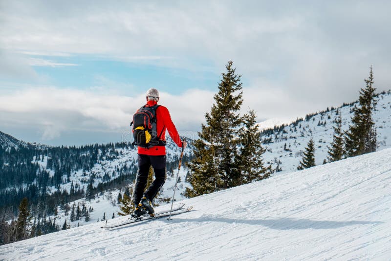 Senior muž lyžařská túra chůzi při pohledu na krajinu
