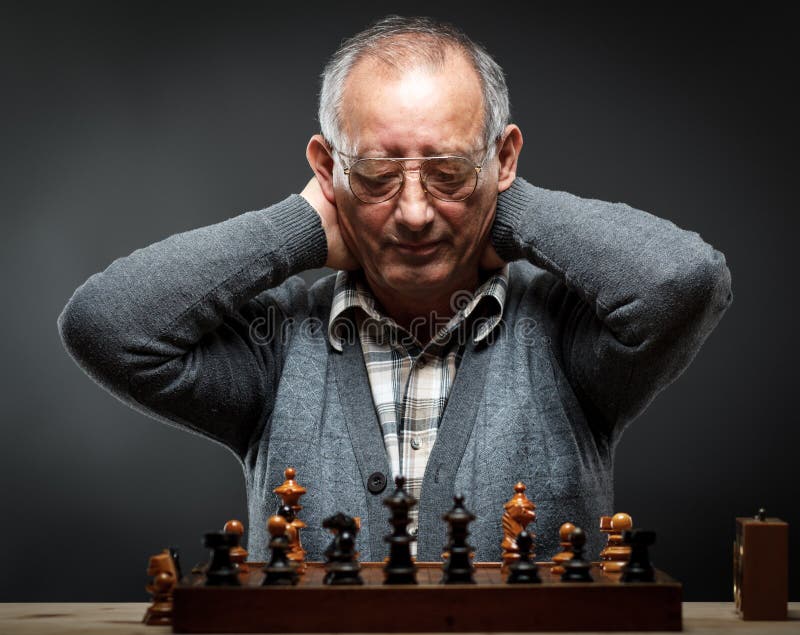 man studying the next chess move Stock Photo - Alamy