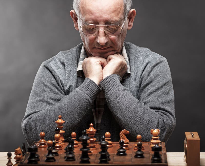 Senior man thinking about his next move in a game of chess Stock Photo by  dmytros9