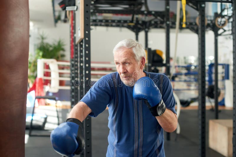 Senior man training with a punching bag.