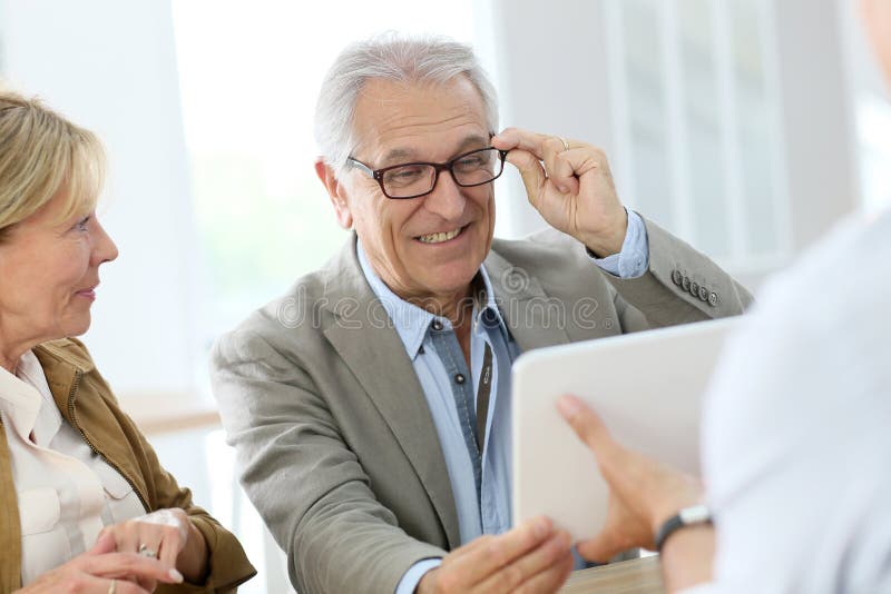 Senior man trying on eyeglasses in optical store